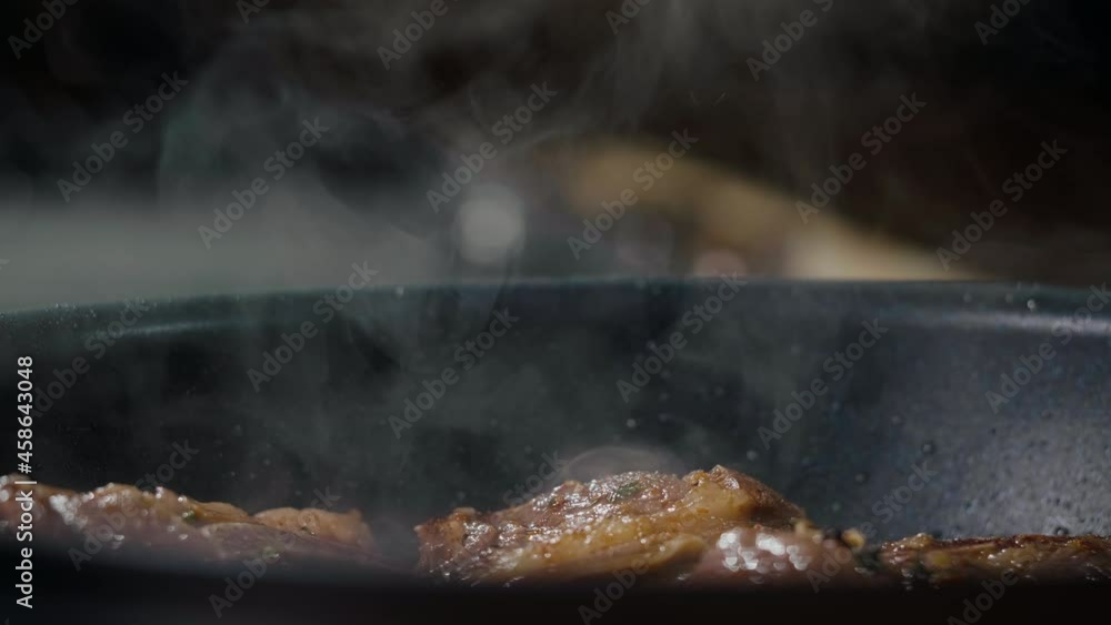 Steam from Steak Cooking in a Pan. Concept delicious food. Steaming frying appetizing meat. Steam from Steak Cooking in a Pan. Concept delicious food. Steaming frying appetizing meat.