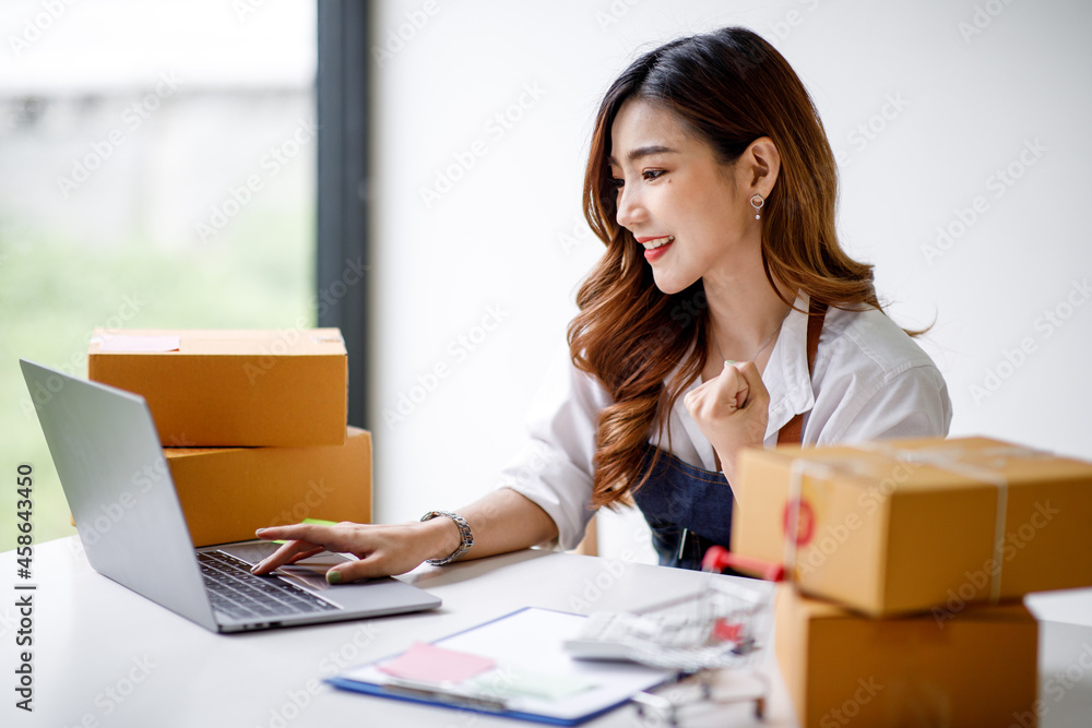 Portrait of Starting small businesses SME owners female entrepreneurs working on receipt box and check online orders to prepare to pack the boxes, sell to customers, sme business ideas online. Portrait of Starting small businesses SME owners female entrepreneurs working on receipt box and check online orders to prepare to pack the boxes, sell to customers, sme business ideas online.