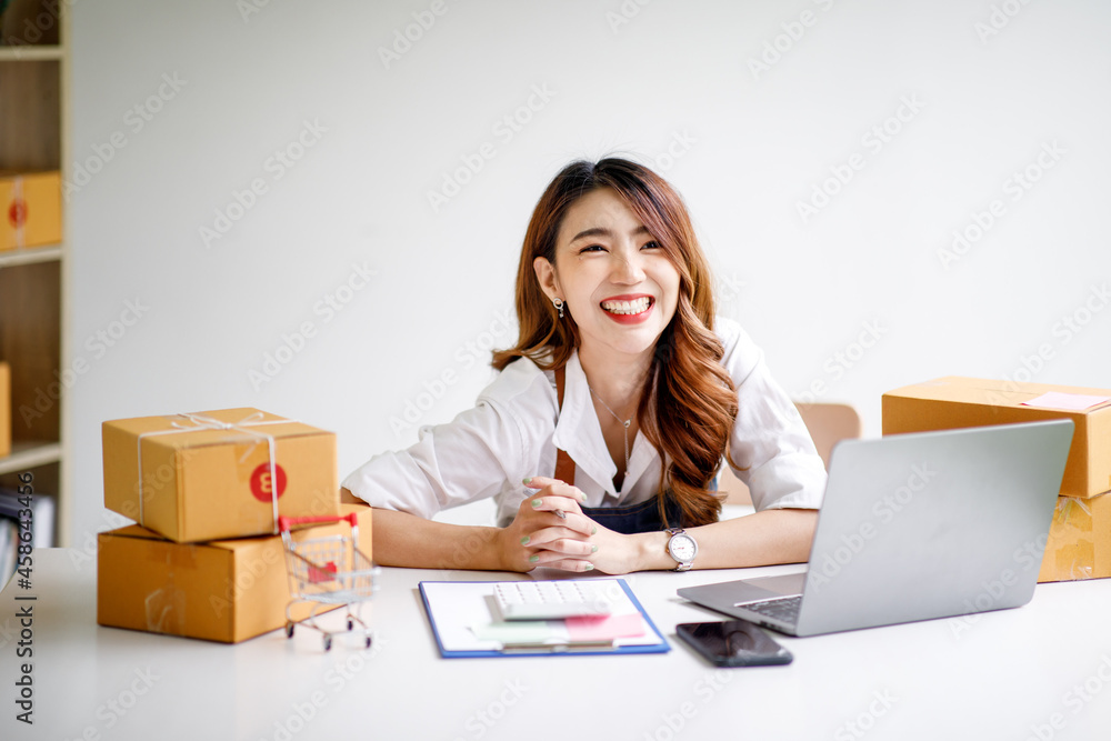 Portrait of Starting small businesses SME owners female entrepreneurs working on receipt box and check online orders to prepare to pack the boxes, sell to customers, sme business ideas online. Portrait of Starting small businesses SME owners female entrepreneurs working on receipt box and check online orders to prepare to pack the boxes, sell to customers, sme business ideas online.
