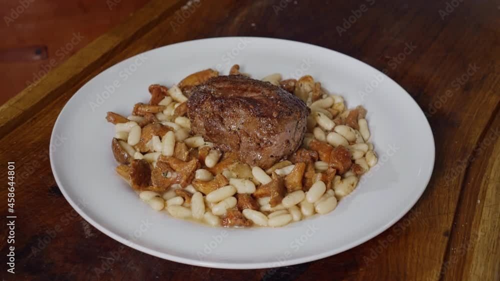 Professional chef cooking in kitchen. Tasty dish with beef steak and beans.Slow Motion Food Footage. Professional chef cooking in kitchen. Tasty dish with beef steak and beans.Slow Motion Food Footage.