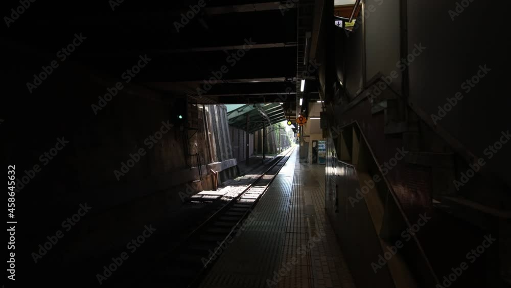 Walking the platform in Tokyo. Old wall and sun beam comes in. Walking the platform in Tokyo. Old wall and sun beam comes in.