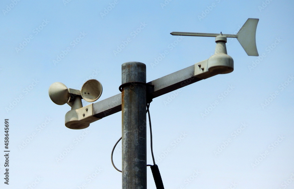 view of a windpane and anemometer against blue sky view of a windpane and anemometer against blue sky