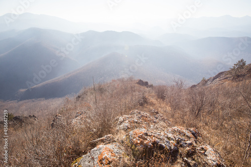 View from above. Autumn forest in the Primorsky Territory. A view from the top of Sakharnaya Mountain near Dalnegorsk to a dry autumn forest. photo