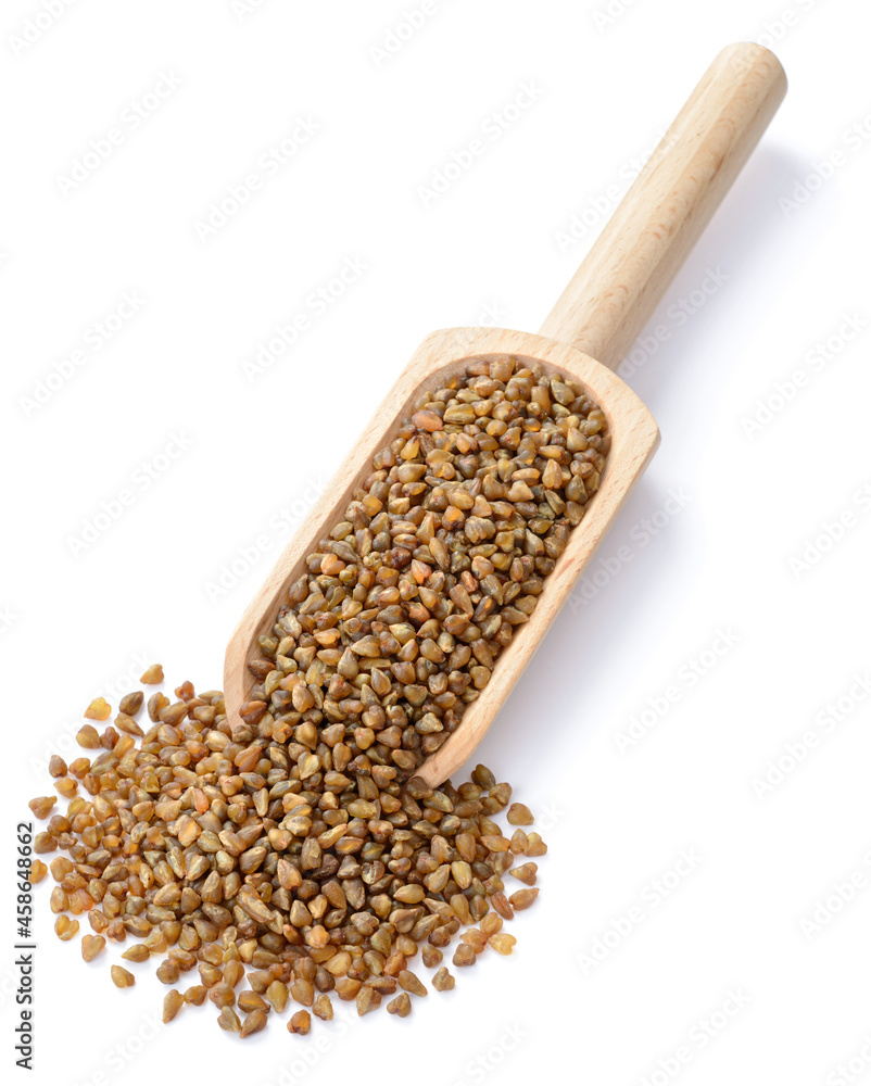 uncooked buckwheat in the wooden scoop, isolated on the white background uncooked buckwheat in the wooden scoop, isolated on the white background
