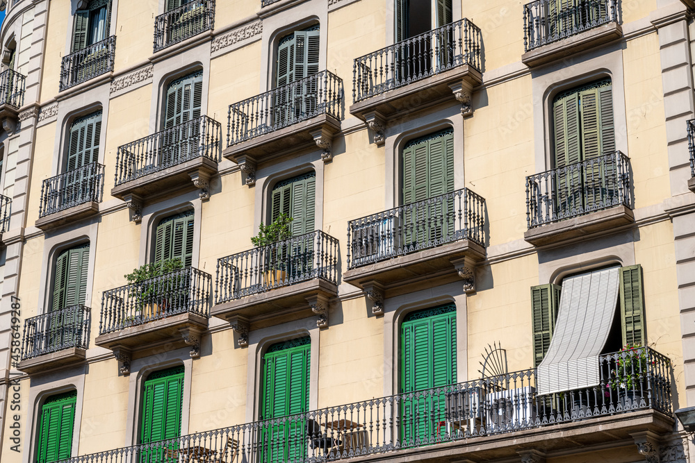 Typical house facades of an apartment building in Barcelona, Spain