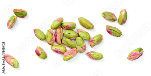 peeled pistachios isolated on the white background, top view