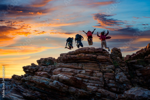 Hikers walking with backpack on a mountain at sunset. traveler going camping. travel concept.