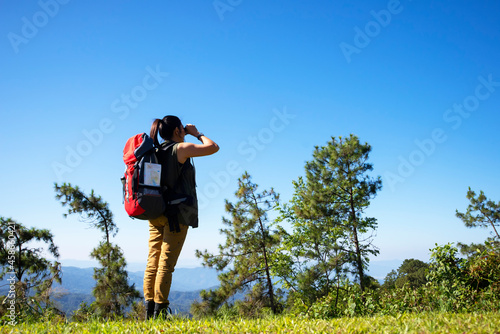 Hiker with backpack relaxing young woman hiking holiday, wild adventure.