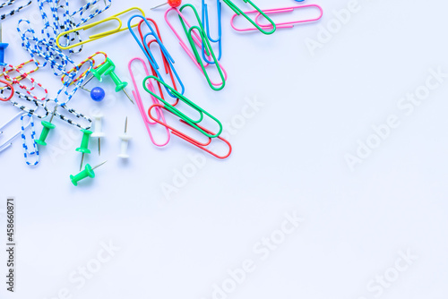 Lots of colorful paper wires scattered on a white background.