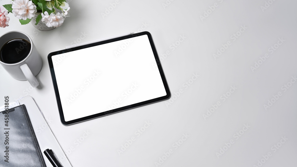 Mock up digital tablet, coffee cup and paperwork on white office desk. Mock up digital tablet, coffee cup and paperwork on white office desk.