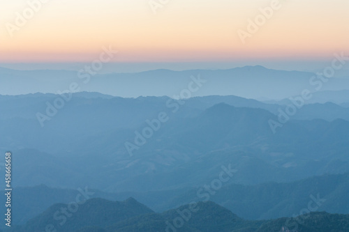 Overlapping mountains landscape at the sunset
