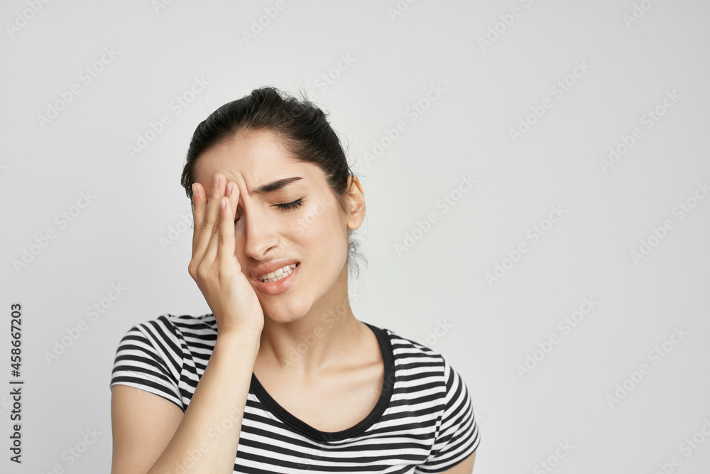 woman in a striped t-shirt pain in the neck isolated background woman in a striped t-shirt pain in the neck isolated background