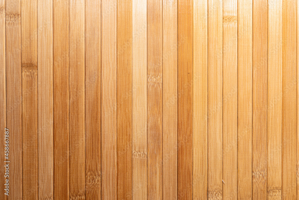 Background made of vertical yellow bamboo laths.texture, background of brown bamboo. Background made of vertical yellow bamboo laths.texture, background of brown bamboo.