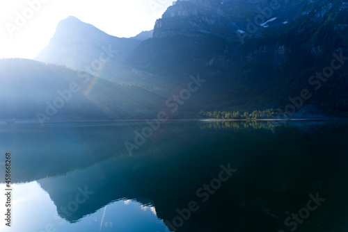 Fototapeta Naklejka Na Ścianę i Meble -  Lake Klöntal at a beautiful late summer morning with reflections in calm water. Photo taken September 4th, 2021, Klöntal, Switzerland.