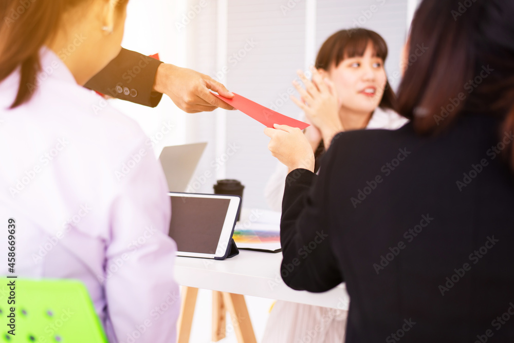Boss giving money annual bonus in red paper to employee office worker once a year Boss giving money annual bonus in red paper to employee office worker once a year