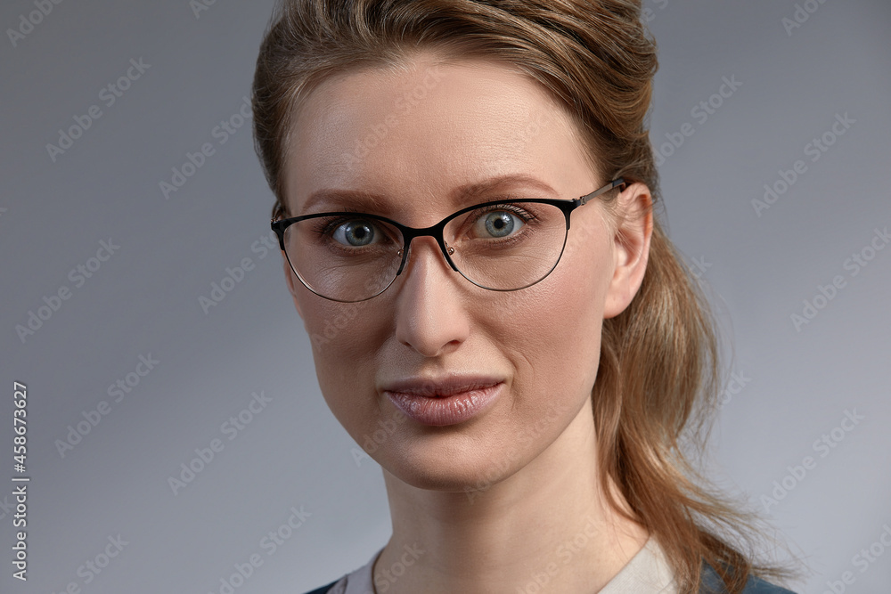 Portrait of nice adorable slim sweet lovely gorgeous attractive winsome cheerful clever smart intelligent wavy-haired lady touching glasses isolated over gray pastel background Portrait of nice adorable slim sweet lovely gorgeous attractive winsome cheerful clever smart intelligent wavy-haired lady touching glasses isolated over gray pastel background