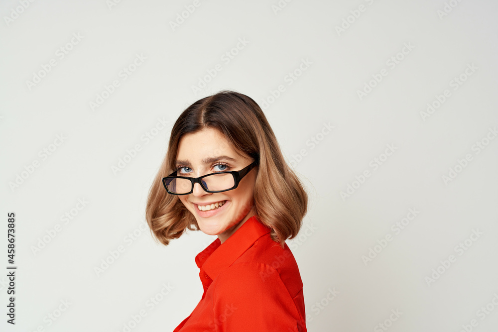 Business woman in red shirt and glasses manager work light background Business woman in red shirt and glasses manager work light background
