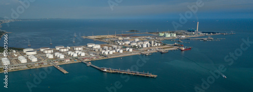 Aerial view oil tertminal storage tank, White oil tank storage chemical petroleum petrochemical refinery product at oil terminal, Business commercial trade fuel energy transport by tanker ship vessel.