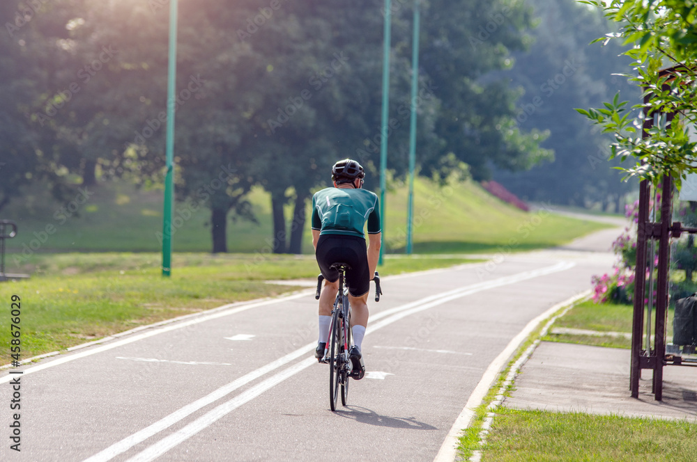 Fototapeta premium Cyclist ride on the bike path in the city Park 