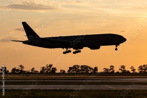 passenger jet airplane landing at airport sunset silhouette logo and branding free image