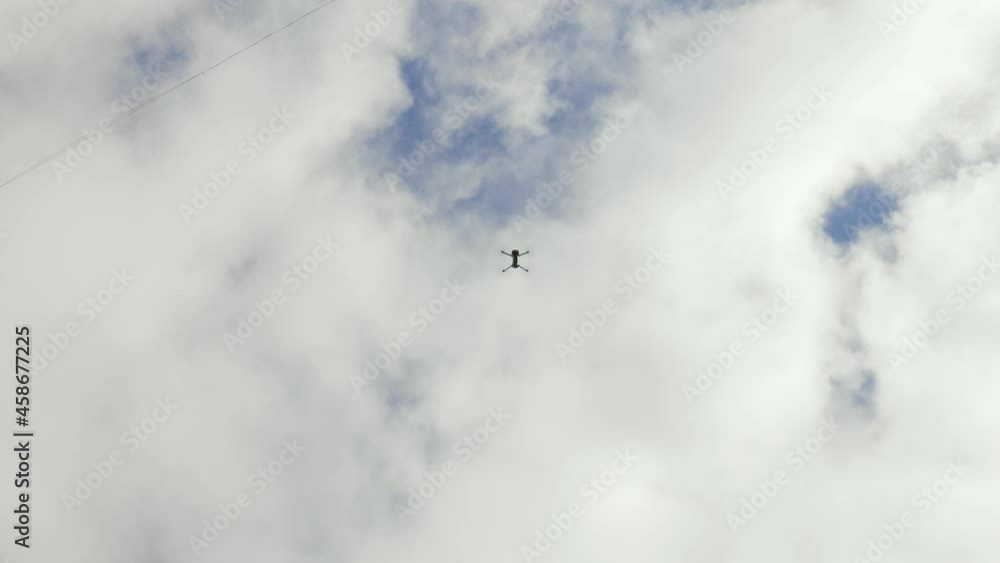 The drone takes off into the cloudy sky The drone takes off into the cloudy sky