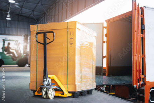 Fotografie, Tablou Cargo Packae Boxes with Hand Pallet Truck Loading into Shipping Container