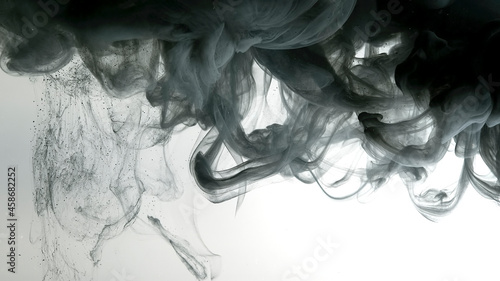 Environmental pollution concept. Black cloud of ink on a white background. Beautiful abstract background. Chic wallpaper for your desktop.