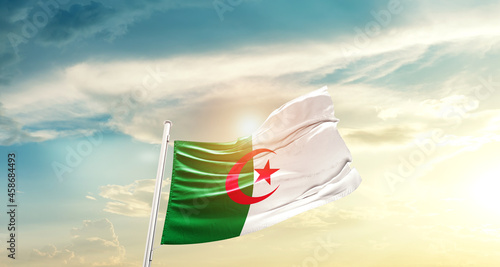 Algeria national flag cloth fabric waving on beautiful sky - Image