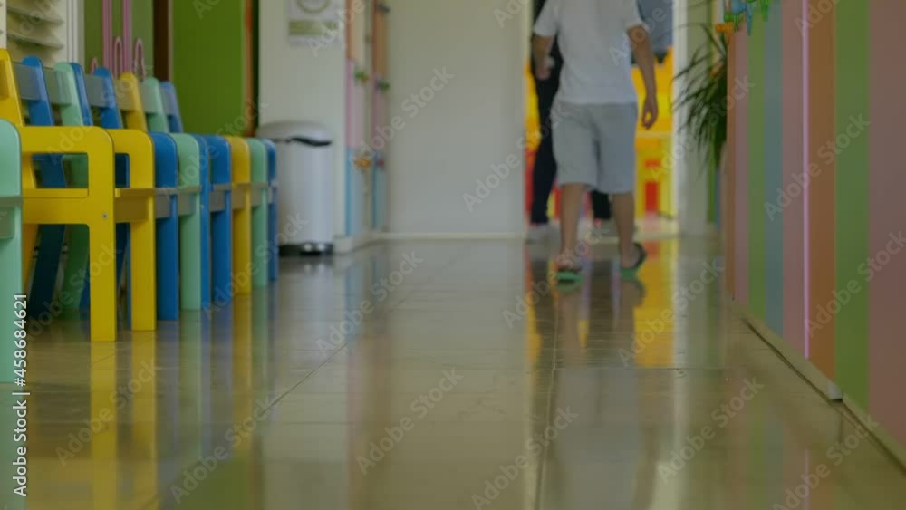Legs of a boy walking along the kindergarten corridor. Children at preschool. Legs of a boy walking along the kindergarten corridor. Children at preschool.