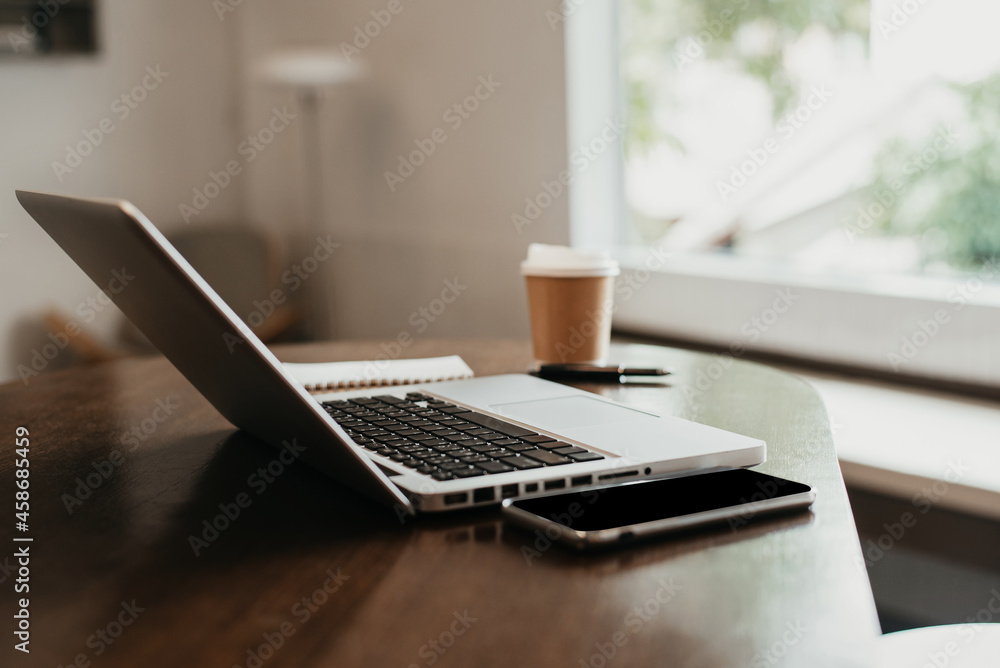 Workplace with notebook laptop and coffee cup Comfortable work table in cafe. Workplace with notebook laptop and coffee cup Comfortable work table in cafe.