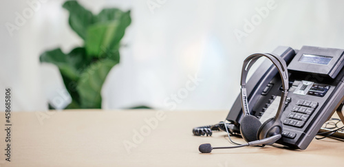 Communication support, call center and customer service help desk. telephone devices with VOIP headset in office.Customer service support (call center) concept.