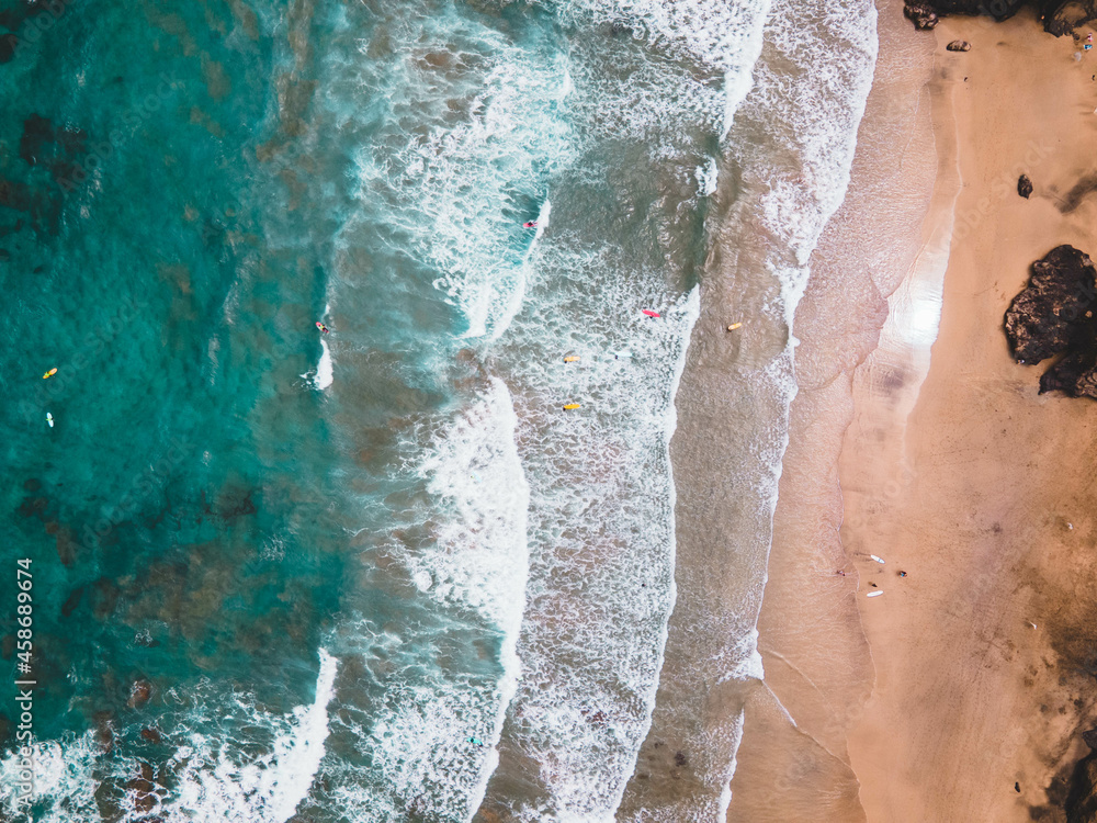 Aerial drone shot of rolling waves on the surf beach at Fuerteventura, Spain. Aerial drone shot of rolling waves on the surf beach at Fuerteventura, Spain.