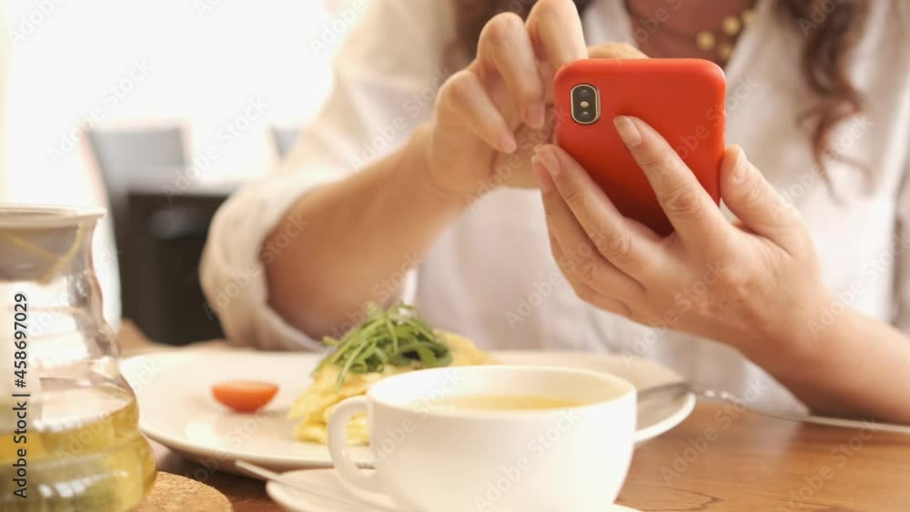 Closeup business woman typing message on mobile phone at restaurant. Close up young woman hands using smartphone . Closeup business woman typing message on mobile phone at restaurant. Close up young woman hands using smartphone .