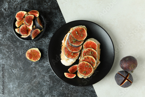 Plate with bruschetta with fig on two tone background