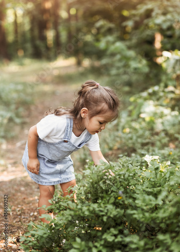 Wallpaper Mural Positive charming little girl enjoying summer sunny day, expression emotions, having fun, happy child walking in summer day Torontodigital.ca