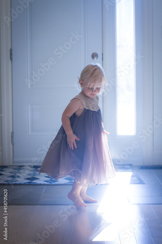Happy toddler girl dancing indoors