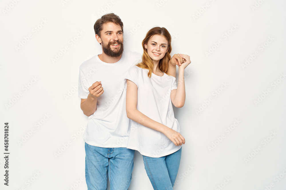 joyful man and woman in white t-shirts embrace friendship together joyful man and woman in white t-shirts embrace friendship together