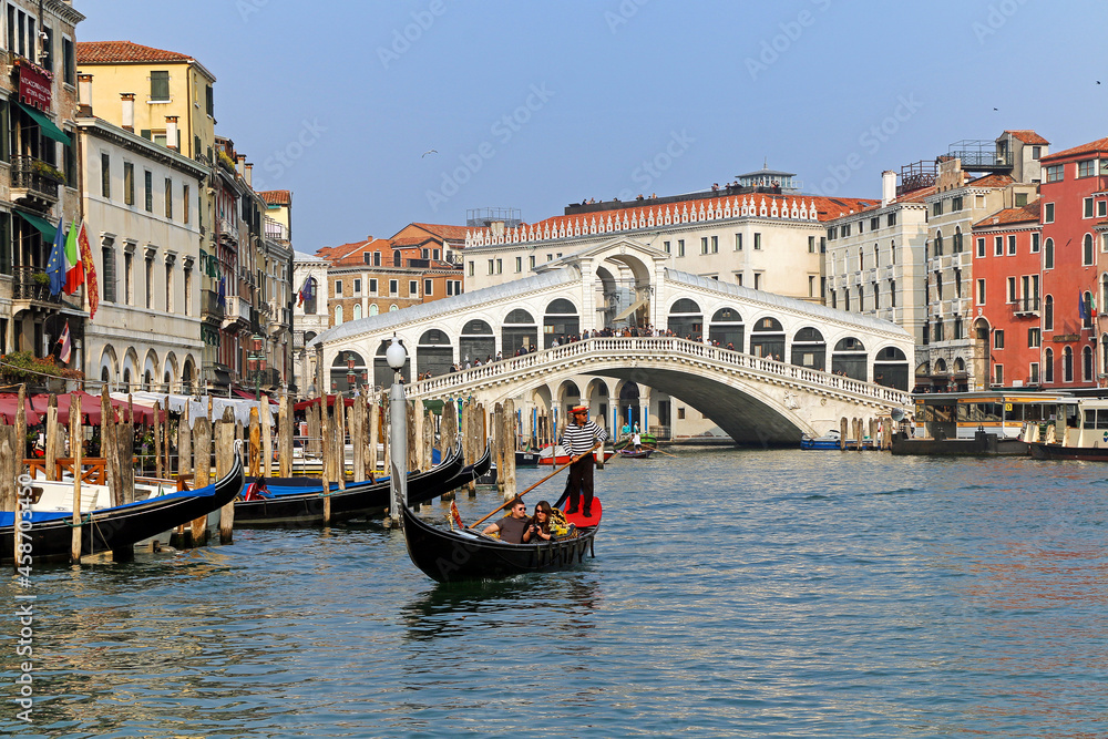 A couple of tourists during a romantic gondola trip on the grand canal, Venice.