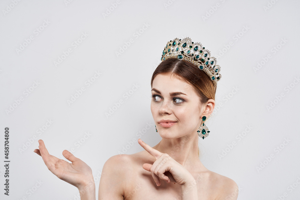 beautiful woman with a crown on her head makeup model isolated background