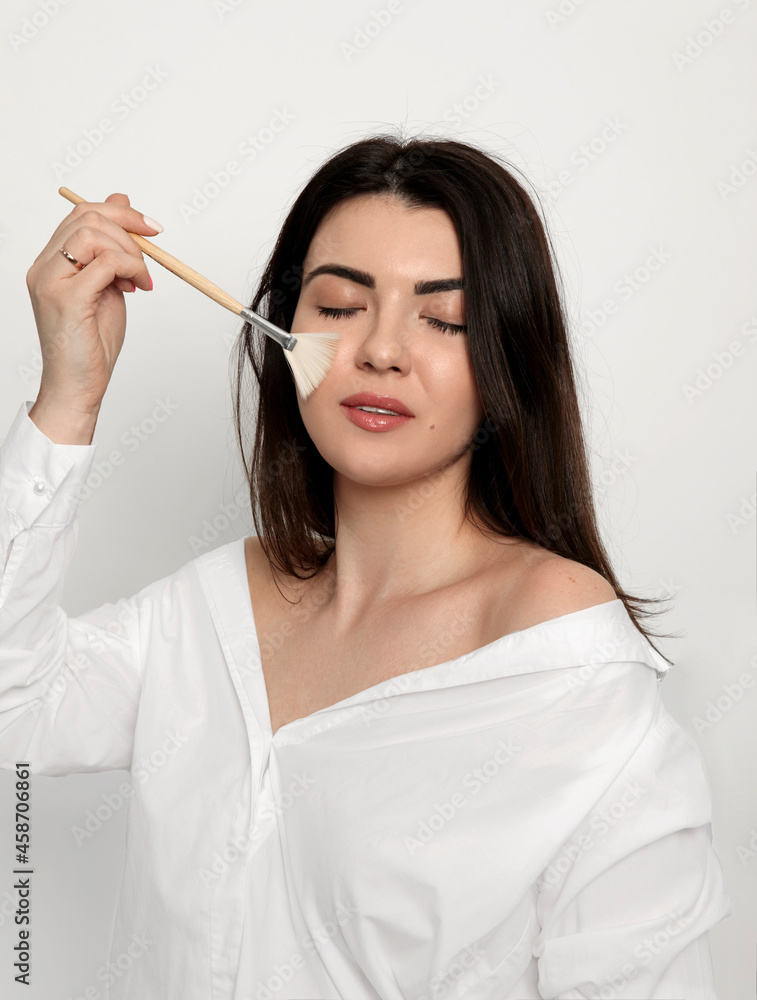 Close-up of a woman's face. The beautician makes a chemical peel. Skin care concept.