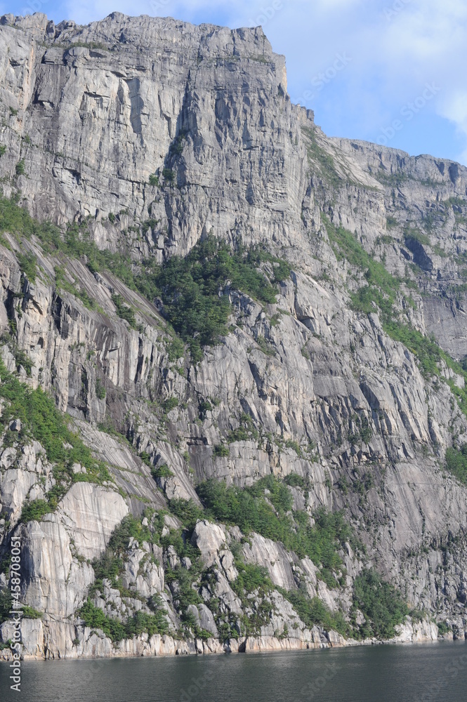 Preikestolen pulpit rock made of granite seen from below from the bottom of Lysefjord fjord and canyon in Norway