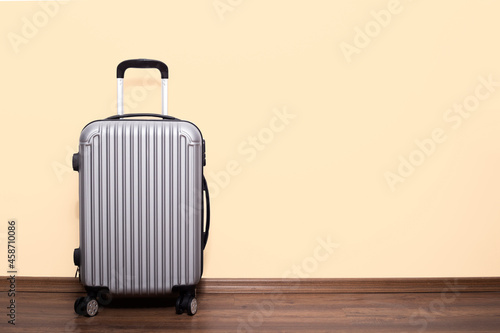 Packed suitcase near color wall. Travel concept
