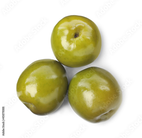 Three fresh green olives on white background, top view