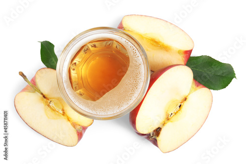 Delicious cider in glass near pieces of ripe apple on white background, top view