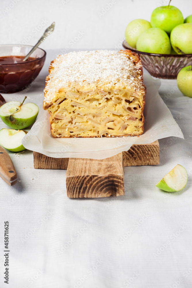 Apple and coconut loaf cake on wooden cutting board Apple and coconut loaf cake on wooden cutting board