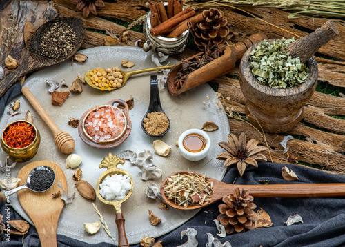 Various spices and herbs in rustic style with honey on balck background. Natural herbs medicine, Organic herbal and healthy concept, Selective focus.