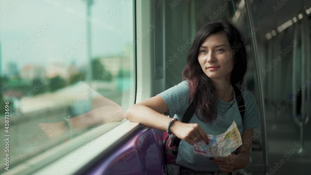 girl travelling in subway and looking in map girl travelling in subway and looking in map