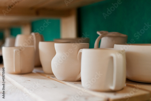 ceramic neutral color clay tableware on the shelf 