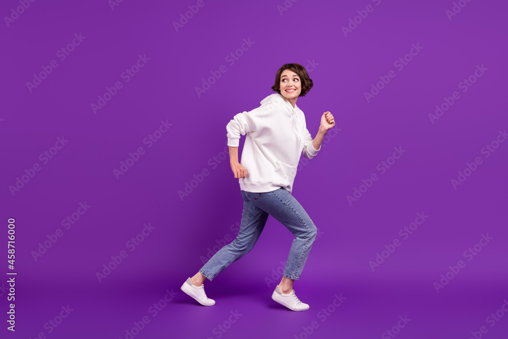 Full size profile side photo of young good mood girl running away playful humorous isolated on purple color background