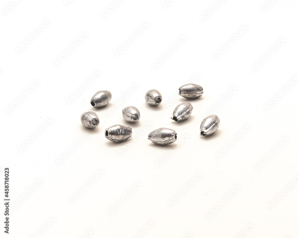 Pile of silver egg sinkers fishing tackle for Carolina rigging casting isolated on white Pile of silver egg sinkers fishing tackle for Carolina rigging casting isolated on white